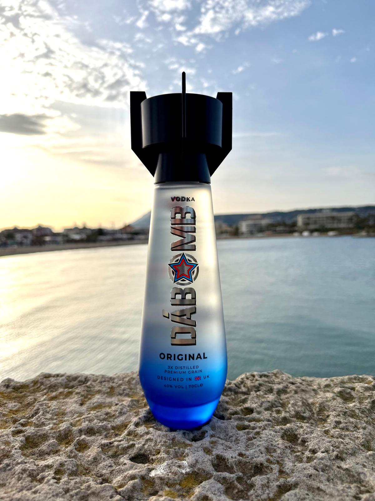 DáBomb Vodka bottle on the Spanish coast at sunset